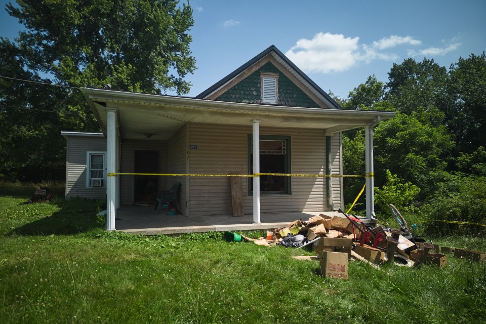 Police tape surrounds a home in Hamden, Ohio, following child abuse arrests.