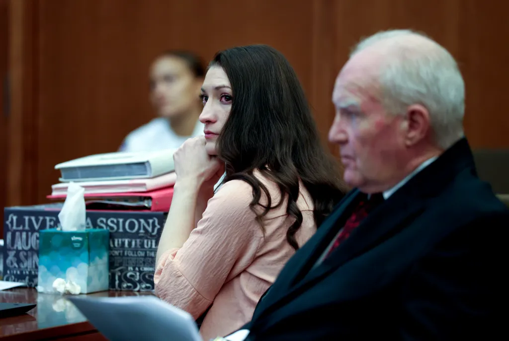 Lindsay Clancy and defense attorney Kevin Reddington listen to testimony in court.