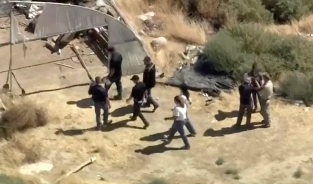 Aerial view of investigators at a remote area where human remains were found.