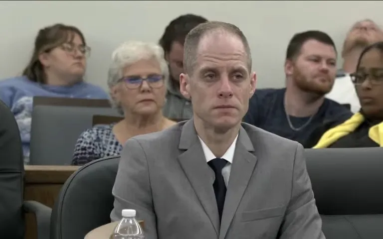 Caleb Flynn sits in a courtroom during closing arguments in his murder trial.