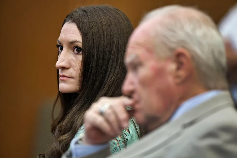 Lindsay Clancy watches jurors enter the courtroom with her defense attorney, Kevin Reddington, beside her.