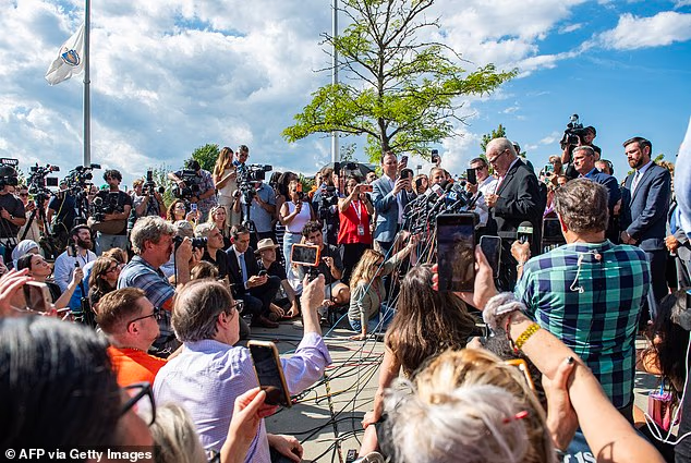Crowd of reporters gather to listen to Kevin Reddington after the mistrial was declared