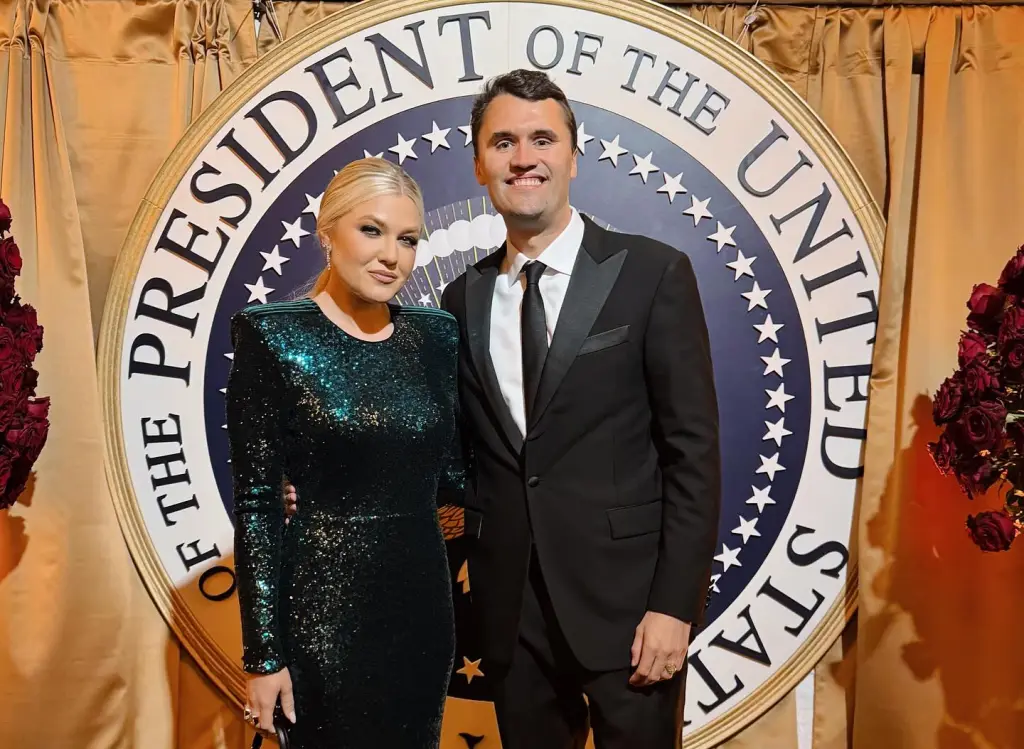 Charlie and Erika Kirk posing in front of the Seal of the President of the United States.