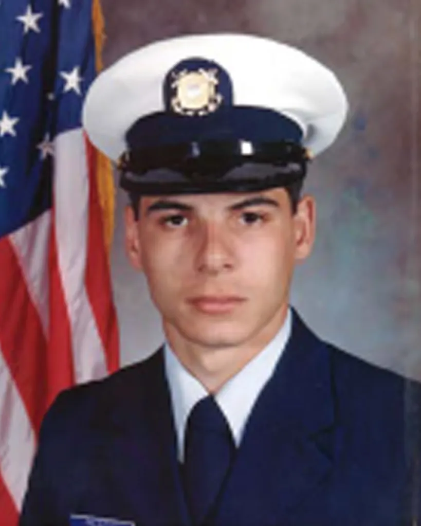 Official portrait of Petty Officer 1st Class Jeffrey Palazzo in uniform, with an American flag behind him.