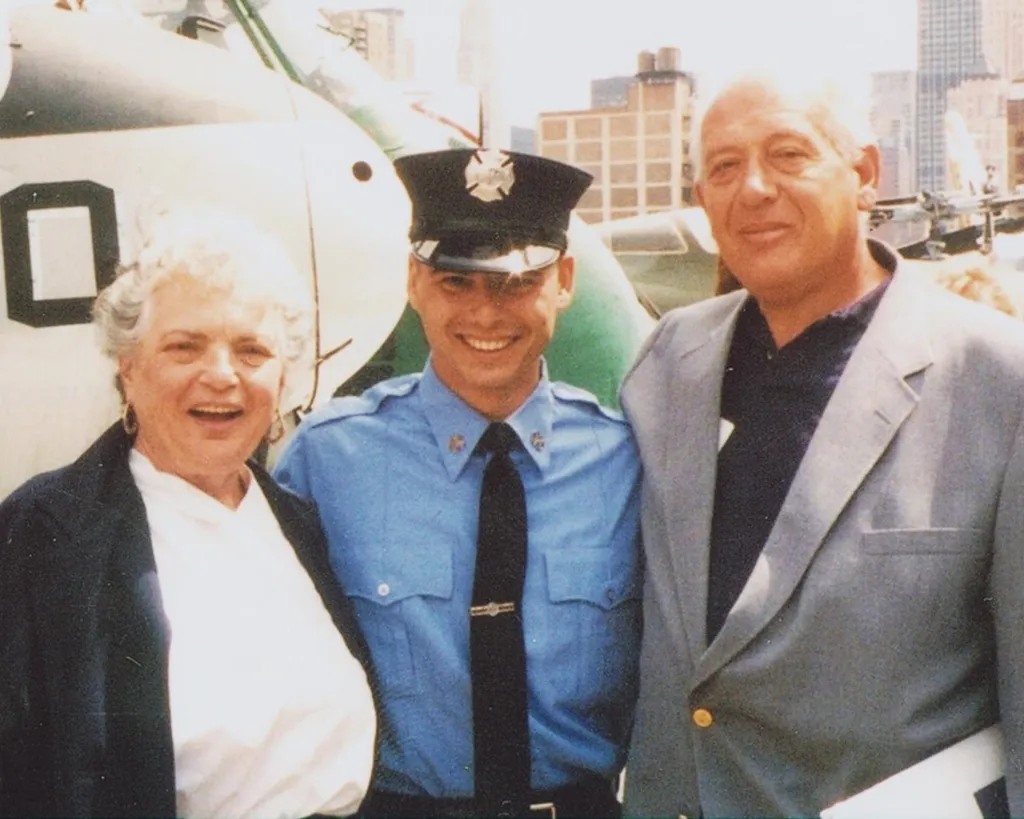 Jeffrey Palazzo, a newly appointed New York firefighter, stands with his parents, Irene and Anthony, at his official induction ceremony.