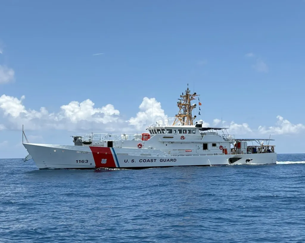 A U.S. Coast Guard Fast Response Cutter, named for Jeffrey Palazzo, sails on the ocean under a blue sky with white clouds.