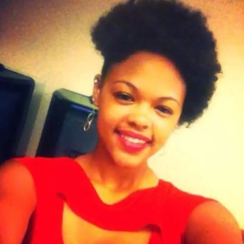 Tasia Fortune, a 29-year-old mother of four, wearing a red top and smiling at the camera.