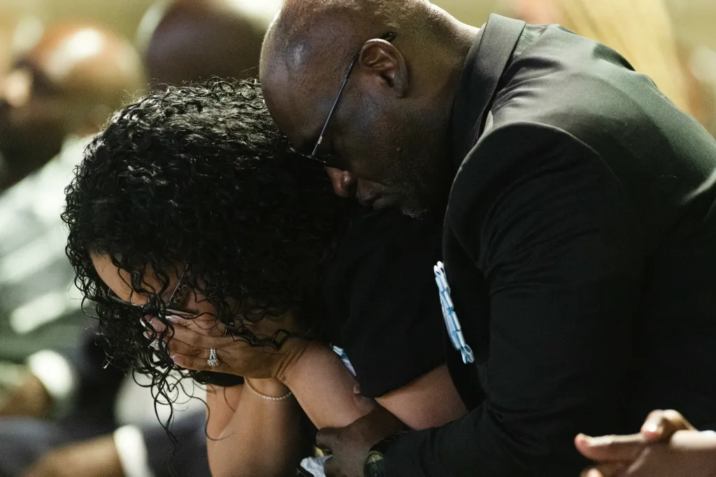 Christine Wells-Wonsley and Elmore Wonsley bow their heads in grief at their son Nolan's funeral.