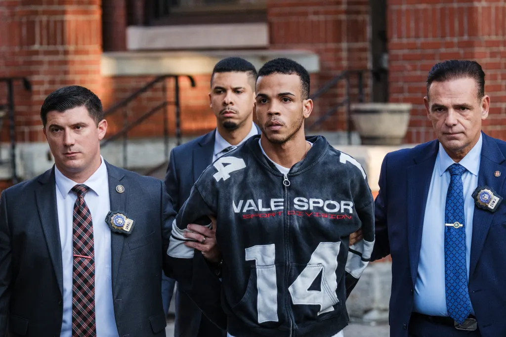 Sneider Mejia is escorted by NYPD detectives in the Bronx, New York.