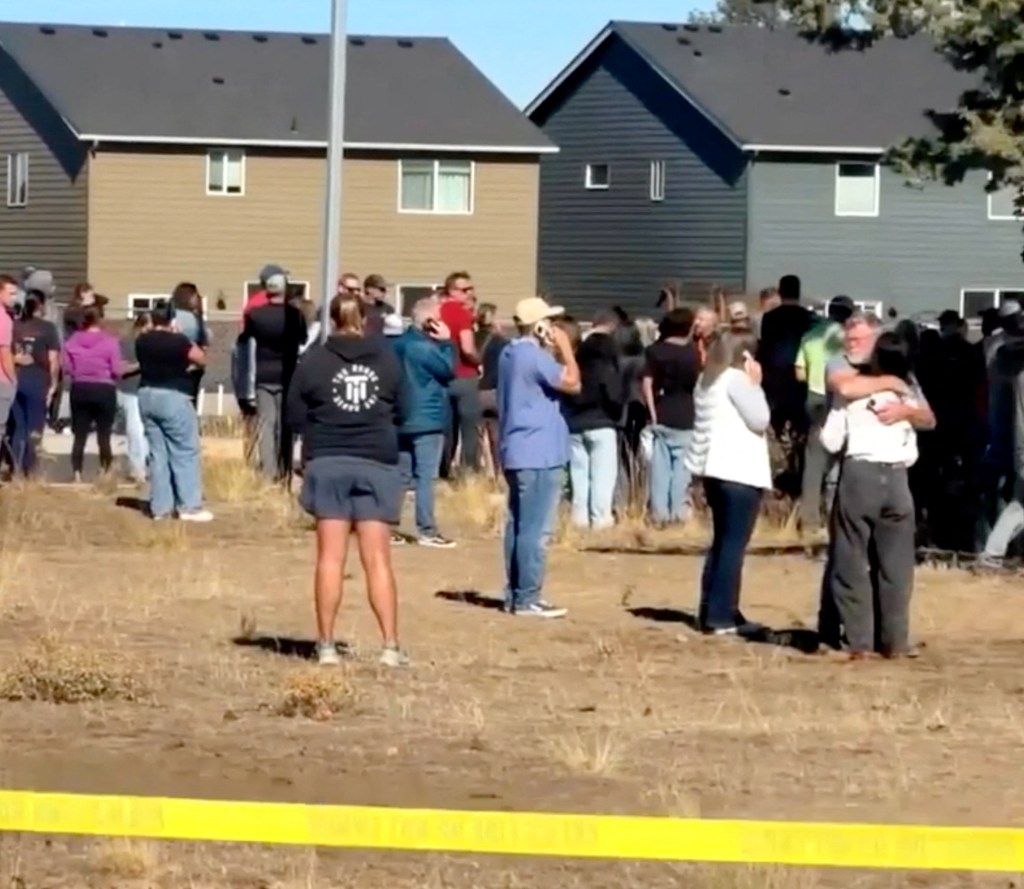 People stand near the scene of a shooting at Silver Rail Elementary School in Bend, Oregon.