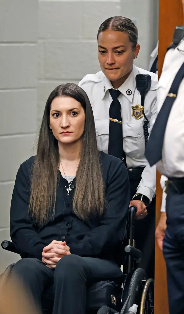 Lindsay Clancy, in a wheelchair and accompanied by a law enforcement officer, is brought into the Plymouth Superior Court.