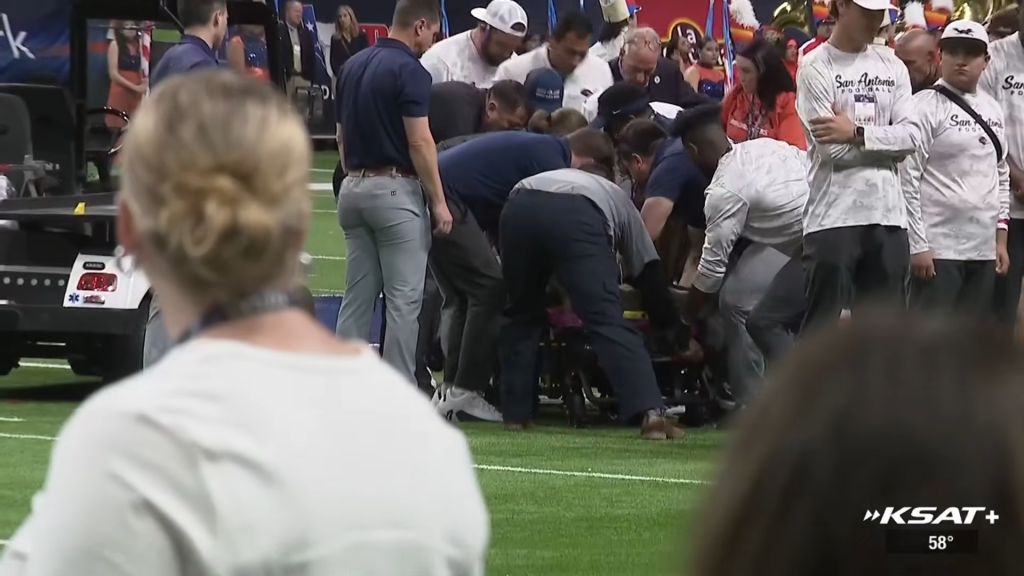 Patterson is attended to on the field at the Alamodome after falling to the ground during a rope rappelling stunt before a game between UTSA and Navy on Oct. 17, 2026.