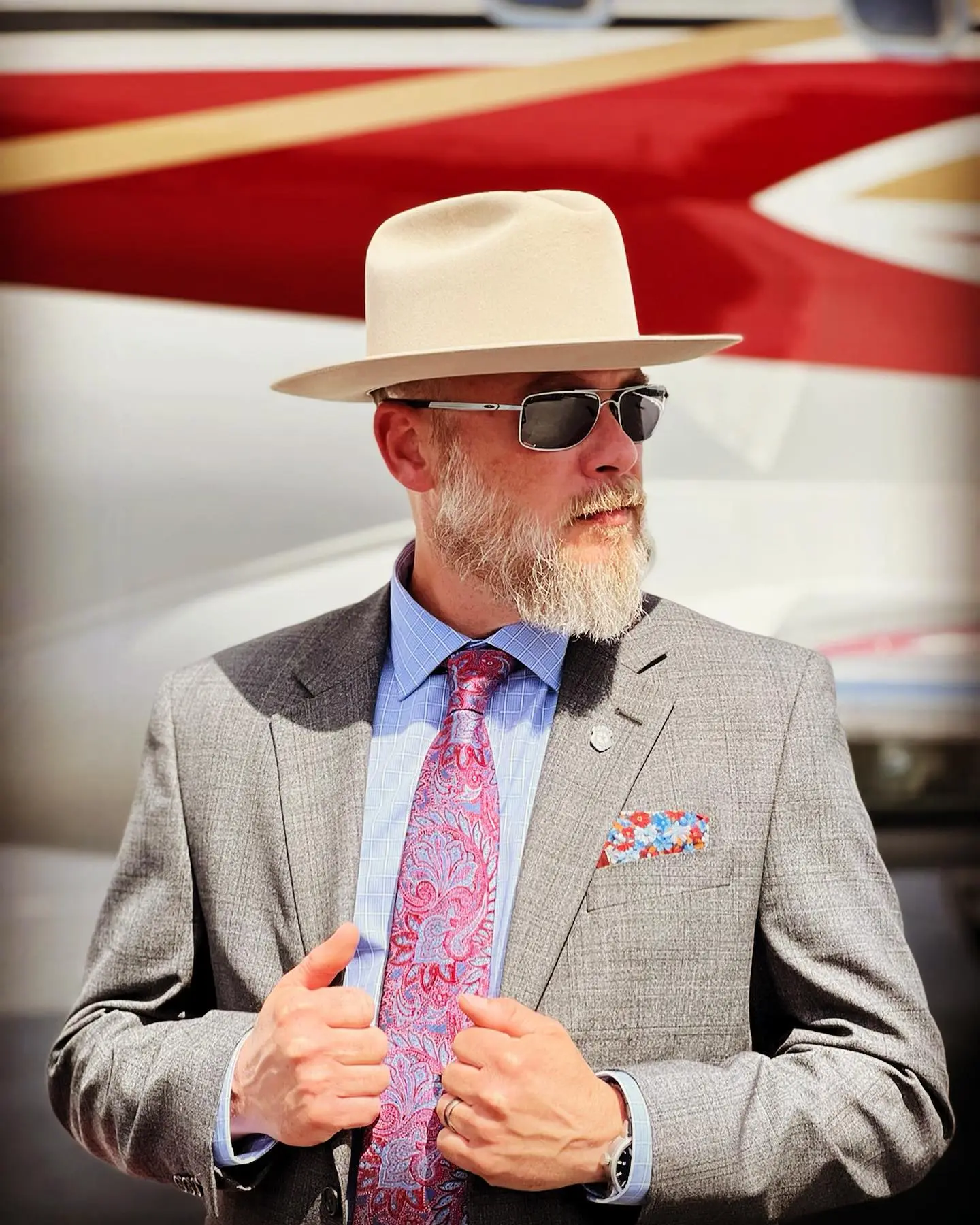 Bryan Seaver wearing a grey suit, fedora, and sunglasses.