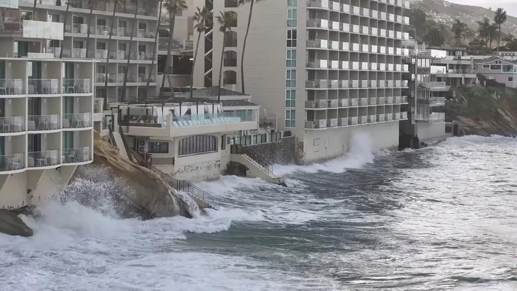 High tides crash against coastal hotels and homes in Laguna Beach.