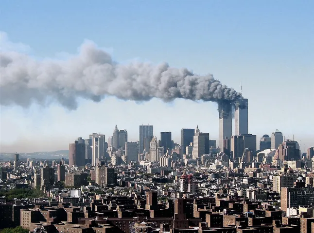 A view of the Twin Towers after they were struck by planes flown by Al Qaida terrorists, as viewed from 37th floor of the southern most building of Waterside Plaza on the East River, between 34th and 25th streets on September 11, 2001 in New York City, New York. (PH๏τo by Lonnie Schlein/Getty Images)