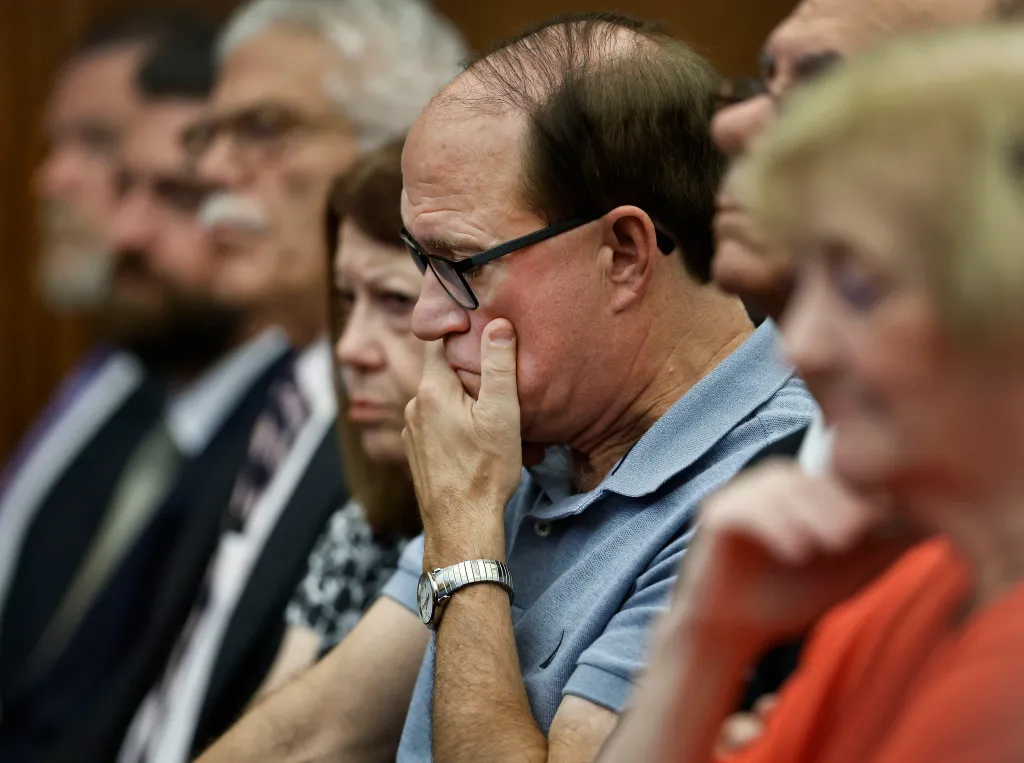 Michael Musgrove listens to testimony in his daughter's murder trial.