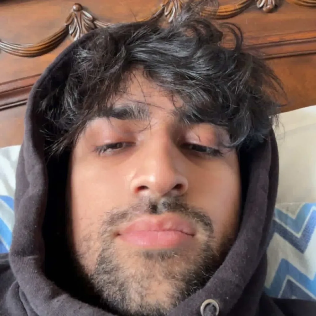 Navam Kaul wearing a black hoodie.