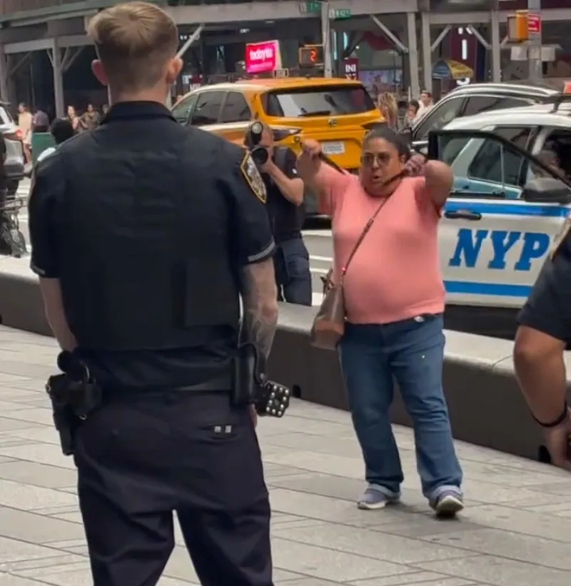 Pamela Cisneros lunges toward police officers in Times Square.