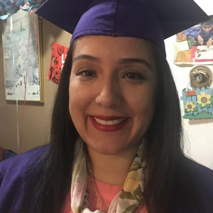 Pamela Cisneros in a cap and gown after graduating from Hunter College.