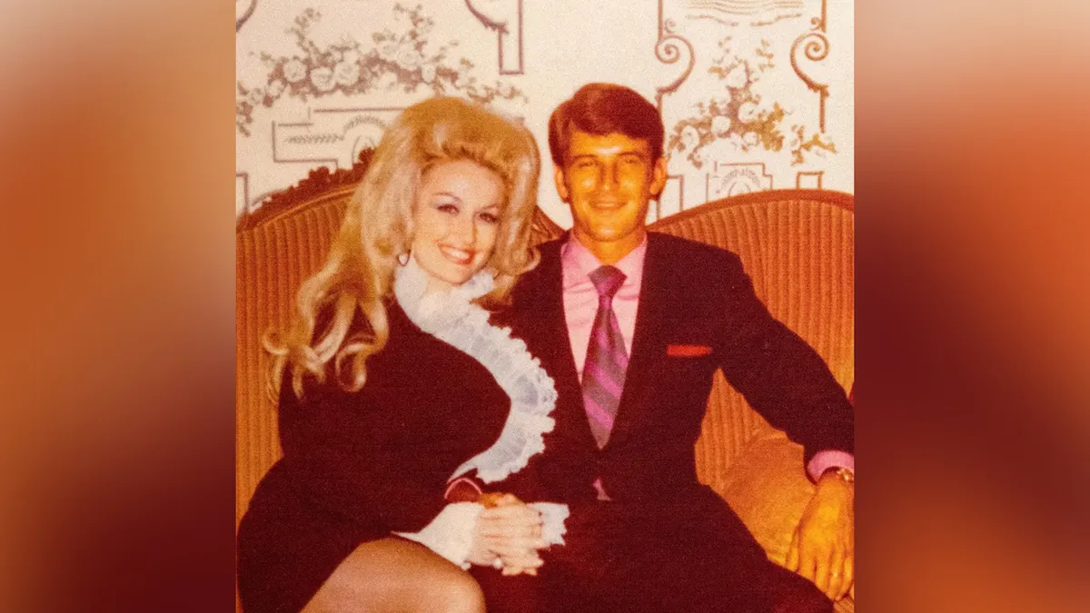 Dolly Parton and Carl Dean sitting on a couch