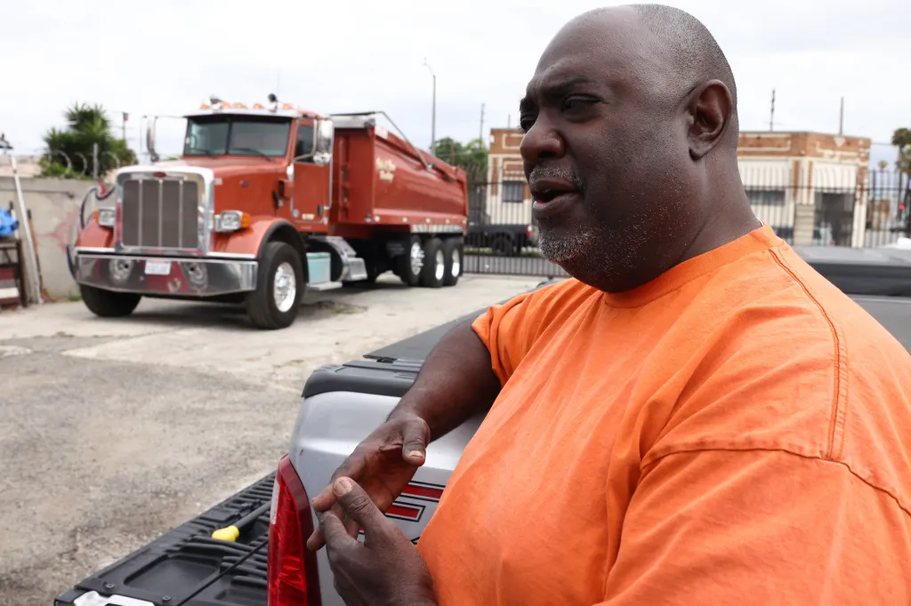 Kenyatta Cole standing in front of a dump truck in Los Angeles.