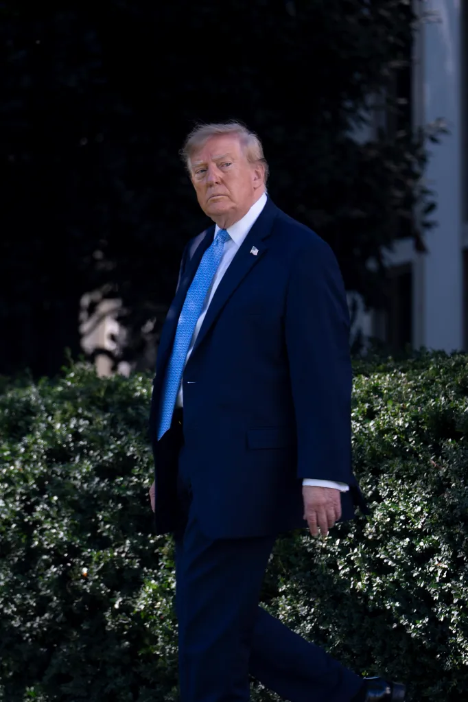 U.S. President Donald Trump walks across the South Lawn of the White House.