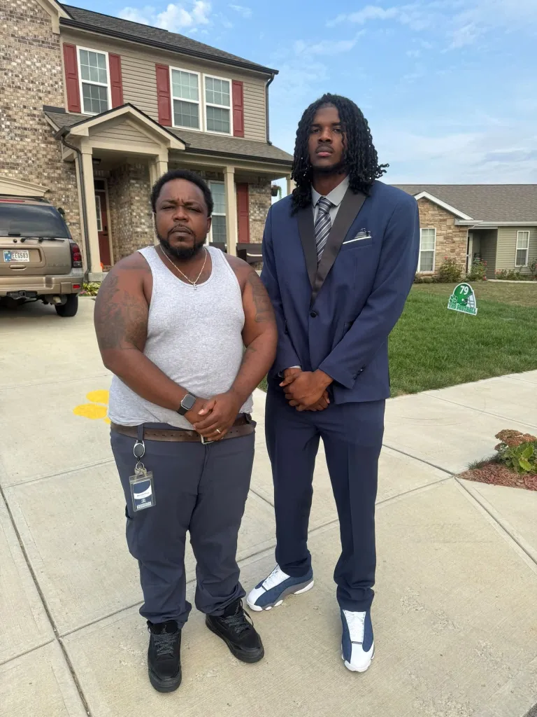 Standout high school footballer player Chris Wilson Jr., poses with his father.