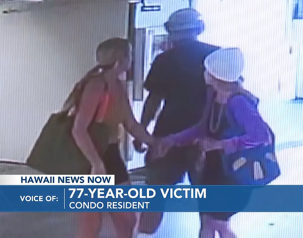 Surveillance video still showing a man confronting two women in a condominium garage.