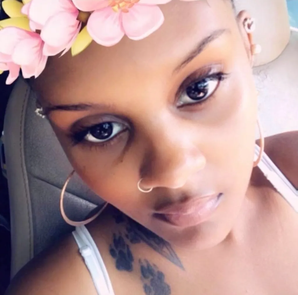 A family grieves near Milford Baptist Church along Milford Church Road in Cobb County, Ga., where 31-year-old Abria Spriggs and her 2-year-old daughter were found dead inside a car on Sunday.