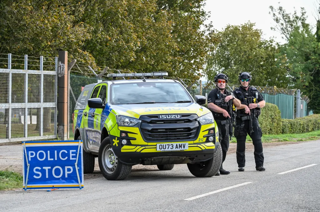 Armed police stand at RAF Fairford after a suspected terror-related incident.