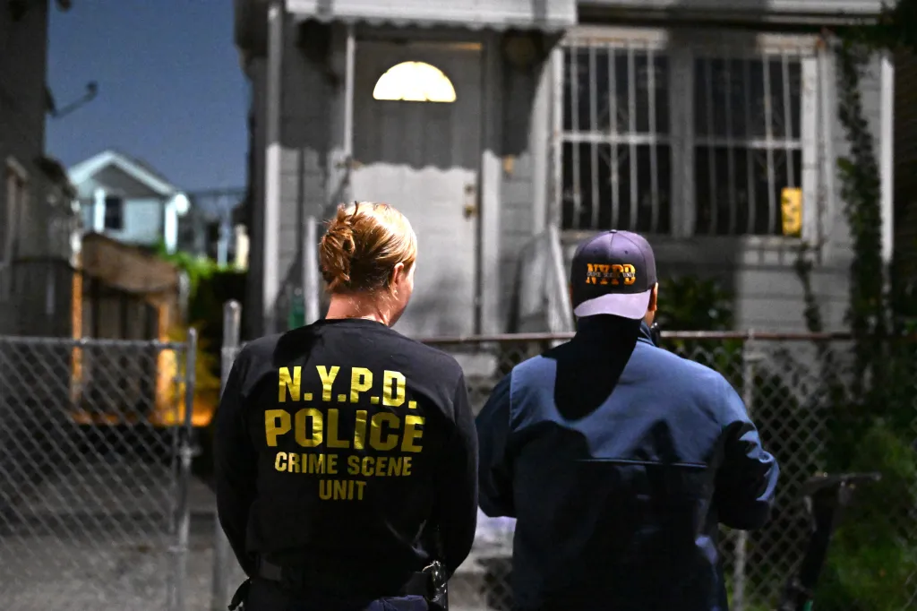 Members of the NYPD Crime Scene Unit investigate a fatal incident in South Jamaica.