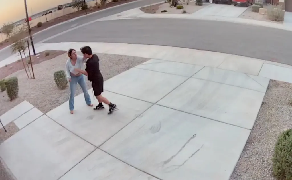 Surveillance camera footage of a woman fighting off an attacker in her driveway.