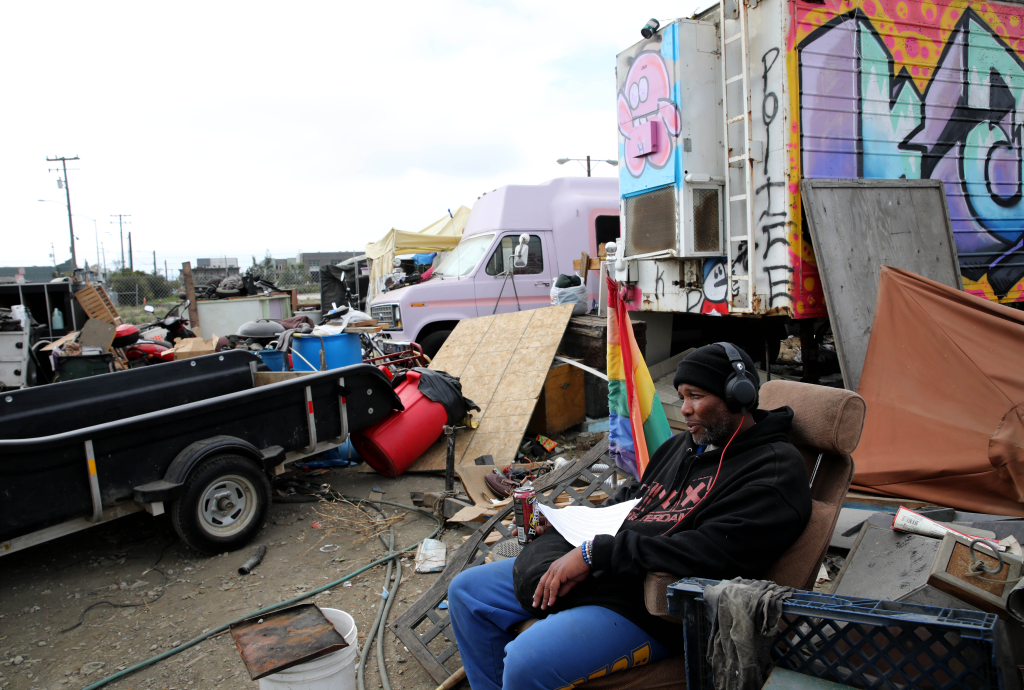 Larry Coke, 56, sits in his recliner at the Wood Street encampment in Oakland, Calif.
