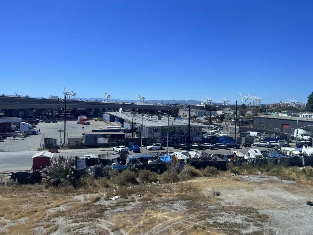 An aerial view of homeless encampments in an industrial area of West Oakland, California.