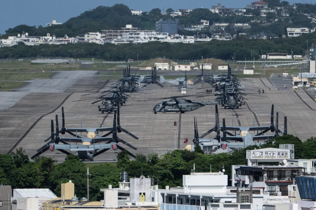 Helicopters and V-22 Ospreys are seen parked on the tarmac near buildings at Marine Corps Air Station Futenma in Ginowan, Okinawa prefecture on Oct. 9, 2026.