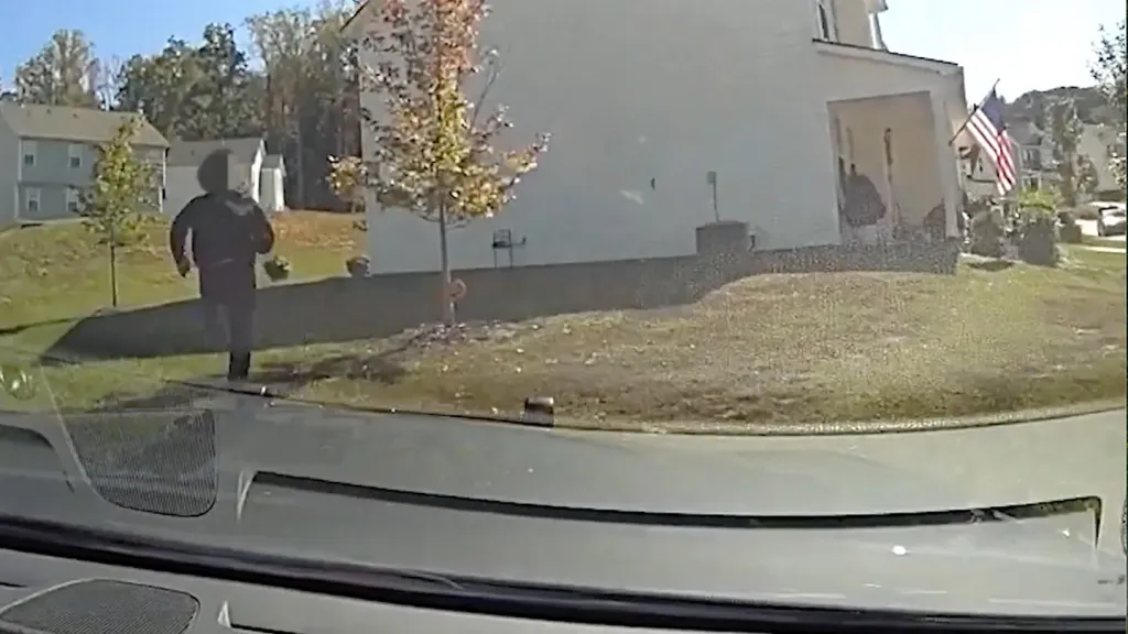Video released by the Greenville County Sheriff’s Office shows the car slamming into the house before deputies rush toward the wreck and chase a fleeing suspect.