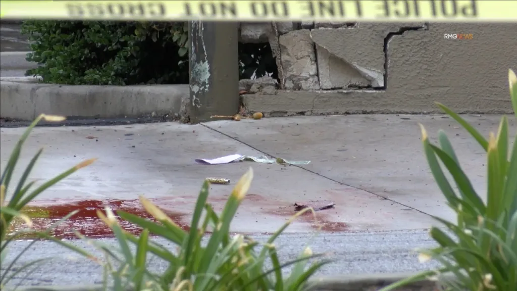 A crime scene on a sidewalk in Arcadia, California, marked with police tape.
