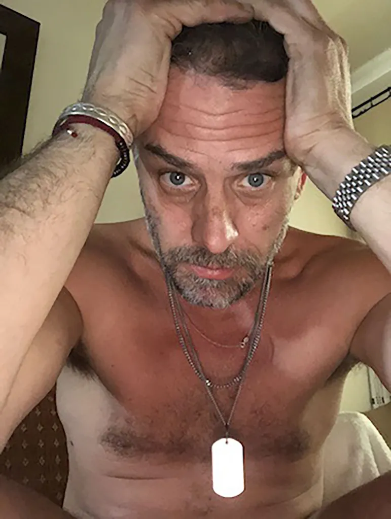 Hunter Biden shirtless with his hands on his head.