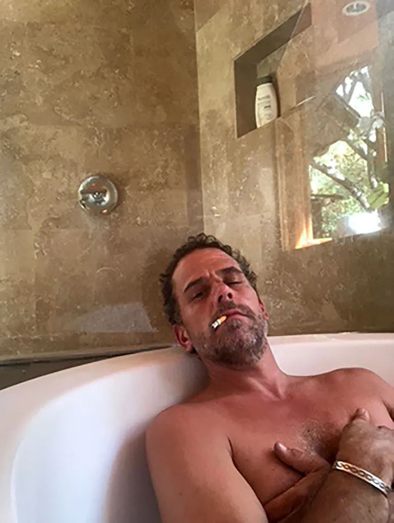 Hunter Biden in a bathtub with a cigarette in his mouth.