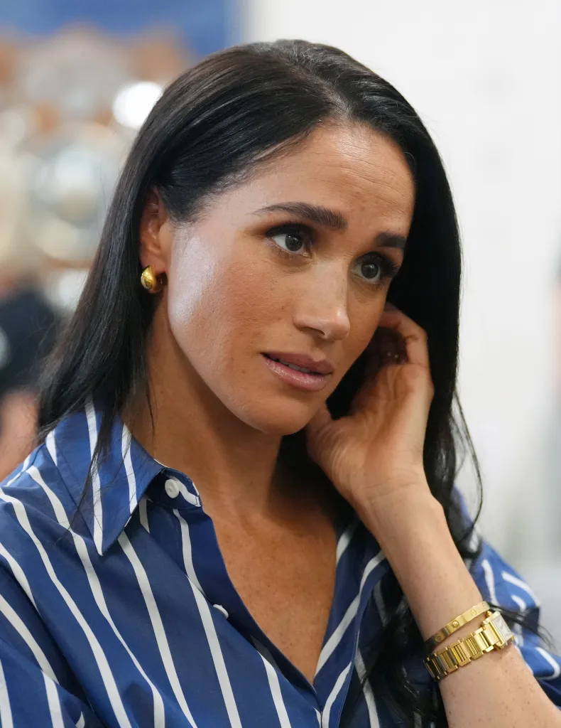 Meghan, Duchess of Sussex, wearing a blue and white striped shirt during a visit to Bondi Beach in Sydney, Australia.