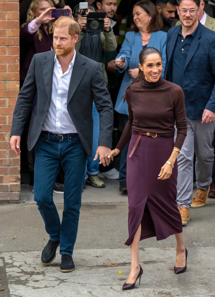 Prince Harry and Meghan Markle holding hands while visiting Nottingham.
