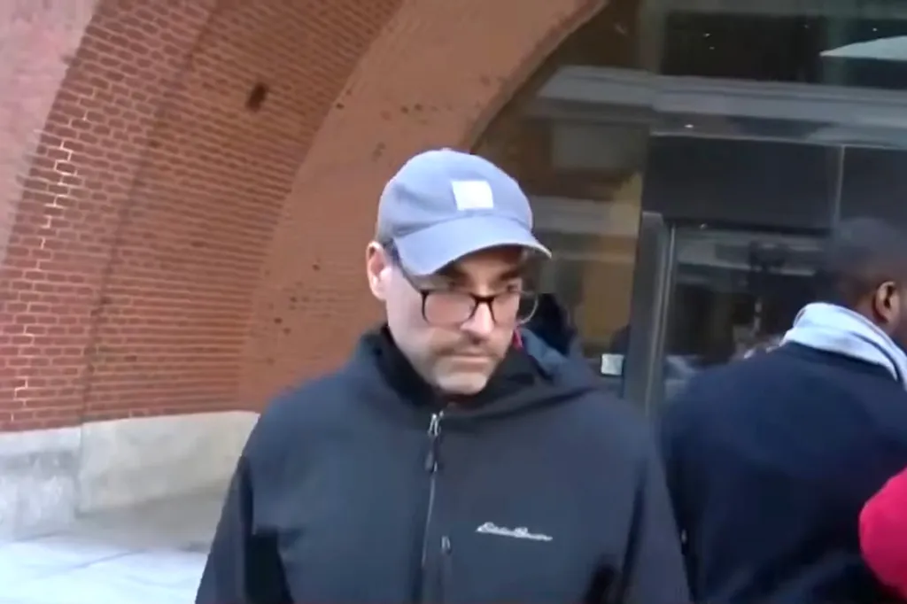 Jonathan Alan Lefman wearing a baseball cap and glasses outside court.