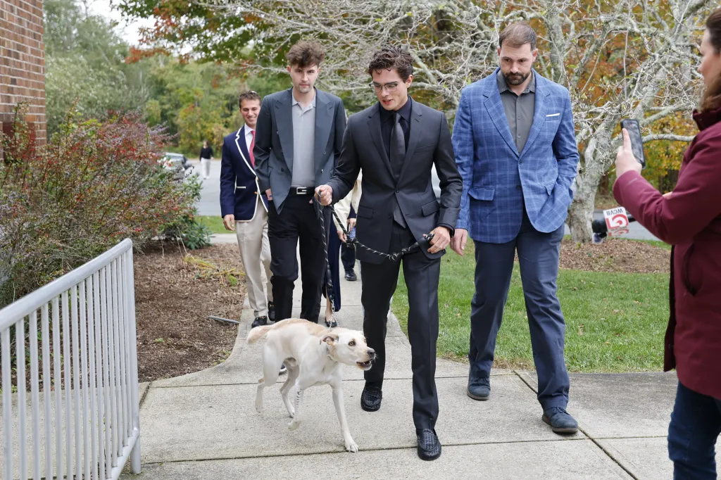 Braden Peters arrives at Orleans District Court in Orleans, Massachusetts, accompanied by a dog and others.