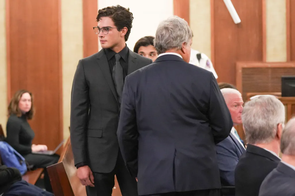 Braden Peters stands in a courtroom during his arraignment.