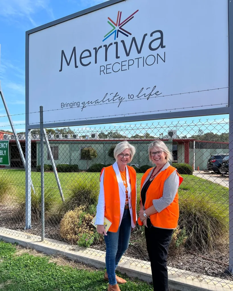 Federal MP Helen Haines stands with Dr Christine Cunningham in front of a Merriwa Reception sign.