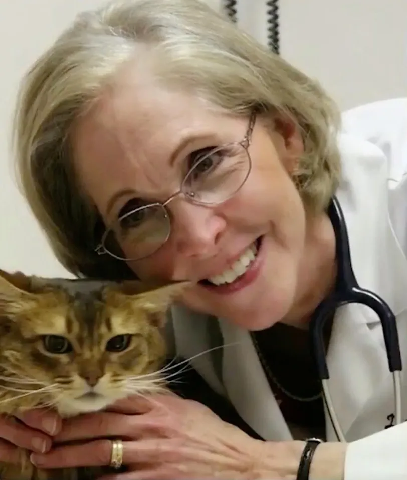 Rebecca Schmidt smiling while holding a cat.