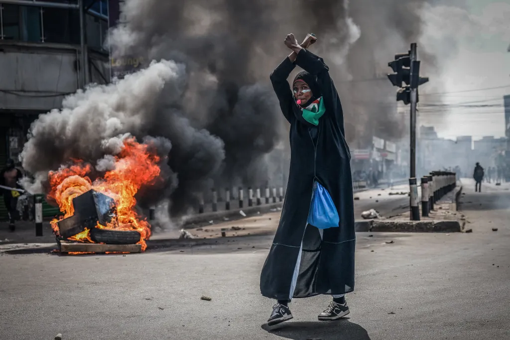 A protester reacts in front of a burning barricade in downtown Nairobi, Kenya, June 25, 2025, during a planned day of protest marking the first anniversary of the storming of parliament.