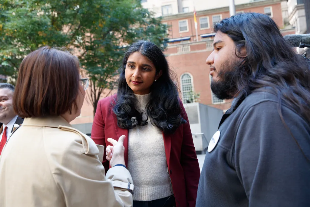 New York Attorney General candidate Saritha Komatireddy listens to a family member during a press conference.