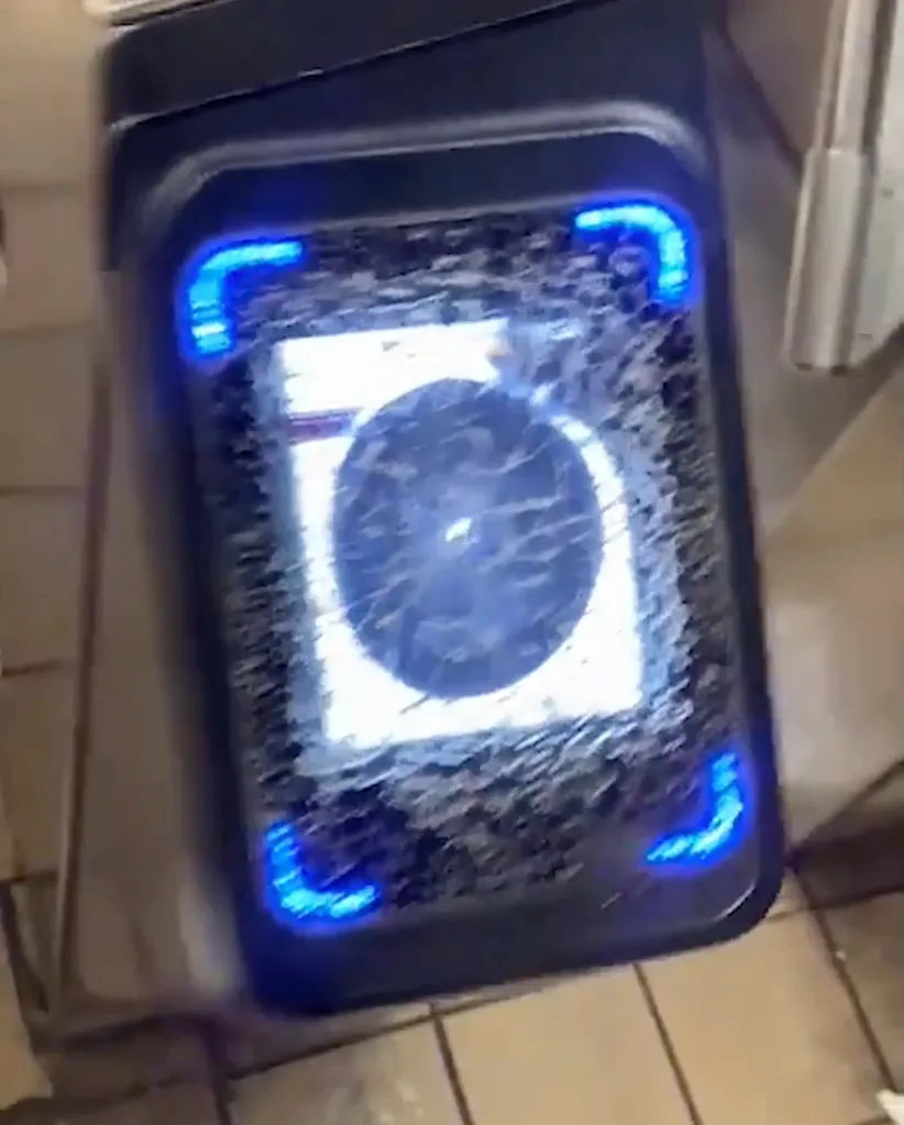 A second masked suspect stood on a folding chair while spray-painting security cameras in the station.