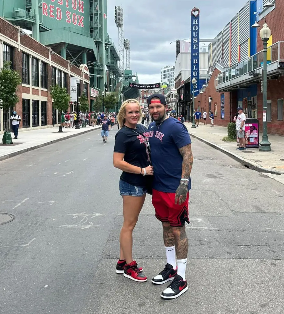 Cody and Honey Phipps standing together on a street near Fenway Park in Boston.